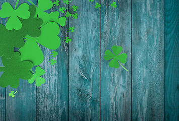 Image showing green paper shamrocks on white background