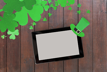 Image showing tablet pc and st patricks day decorations on wood