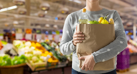 Image showing close up of woman with paper bag full of food