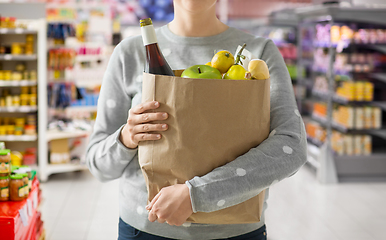 Image showing close up of woman with paper bag full of food