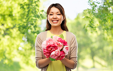 Image showing happy asian woman with bunch of flowers