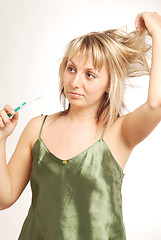 Image showing A young woman with a toothbrush