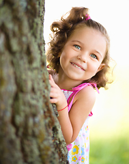 Image showing Cute little girl is playing hide and seek