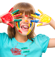 Image showing Portrait of a cute girl playing with paints