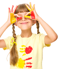 Image showing Portrait of a cute girl playing with paints