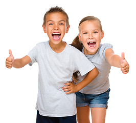 Image showing Little boy and girl are showing thumb up sign