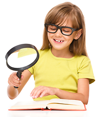 Image showing Little girl is reading book