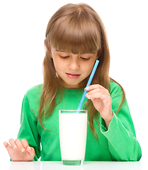 Image showing Gloomy little girl doesn\'t want to drink milk