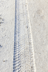 Image showing fingerprint from the car tires on snow close-up