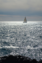 Image showing sail boat at horizon line