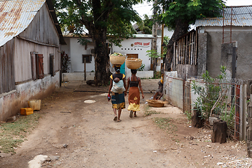 Image showing Malagasy women traditionally carry a basket of fruit on their he