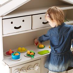 Image showing toddler girl playing with toy kitchen at home