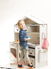 Image showing toddler girl playing with toy kitchen at home