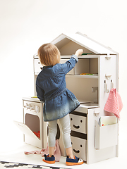 Image showing toddler girl playing with toy kitchen at home