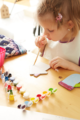 Image showing Cute little girl painting on home interior background