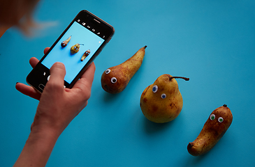 Image showing Three funny pears with googly eyes