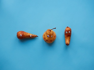 Image showing Three funny pears with googly eyes