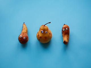 Image showing Three funny pears with googly eyes