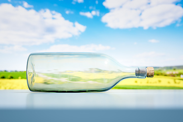 Image showing lying glass bottle landscape scenery background