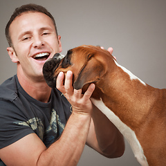 Image showing handsome laughing man with his dog
