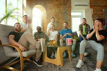 Image showing Group of excited friends playing video games at home