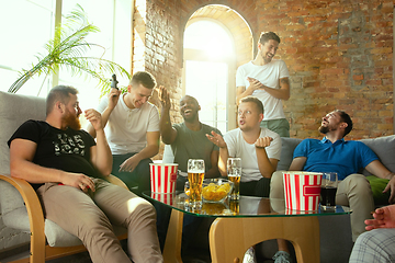 Image showing Group of excited friends playing video games at home