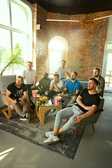 Image showing Group of excited friends playing video games at home