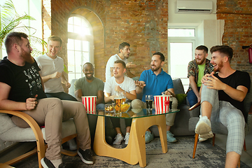 Image showing Group of excited friends playing video games at home