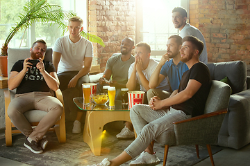 Image showing Group of excited friends playing video games at home