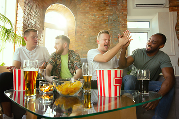 Image showing Group of excited friends playing video games at home