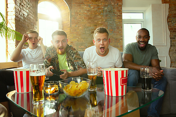 Image showing Group of excited friends playing video games at home