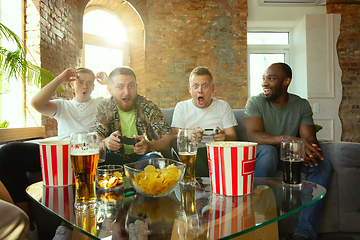 Image showing Group of excited friends playing video games at home