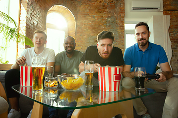 Image showing Group of excited friends playing video games at home