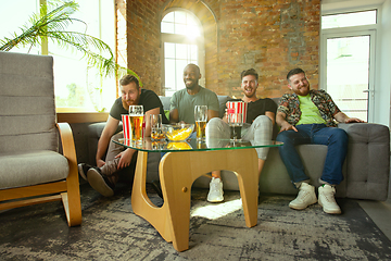 Image showing Group of friends watching football or soccer game on TV at home