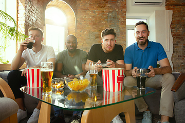 Image showing Group of excited friends playing video games at home