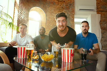 Image showing Group of excited friends playing video games at home