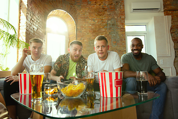 Image showing Group of excited friends playing video games at home