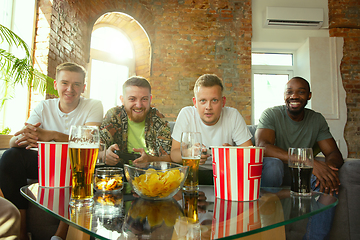 Image showing Group of excited friends playing video games at home