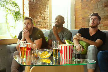 Image showing Group of friends watching football or soccer game on TV at home