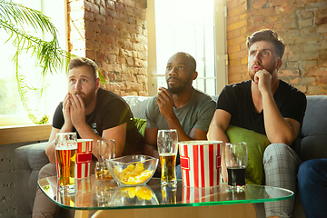 Image showing Group of friends watching football or soccer game on TV at home