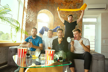 Image showing Group of friends watching football or soccer game on TV at home