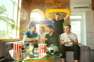 Image showing Group of friends watching football or soccer game on TV at home