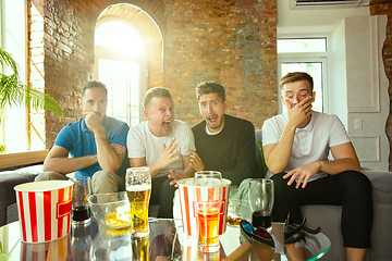 Image showing Group of friends watching football or soccer game on TV at home