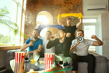 Image showing Group of friends watching football or soccer game on TV at home