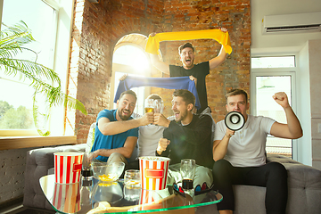 Image showing Group of friends watching football or soccer game on TV at home