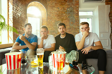 Image showing Group of friends watching football or soccer game on TV at home