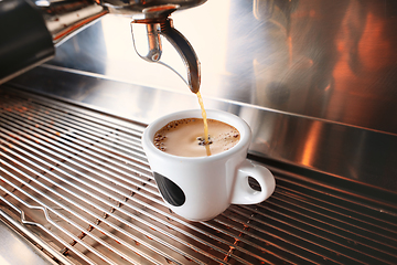 Image showing Stylish black espresso making machine brewing two cups of coffee, shooted in cafe.