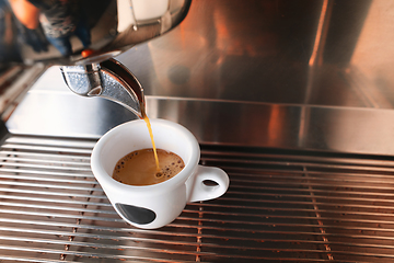 Image showing Stylish black espresso making machine brewing two cups of coffee, shooted in cafe.