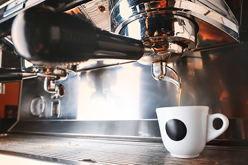 Image showing Stylish black espresso making machine brewing two cups of coffee, shooted in cafe.