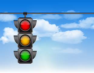 Image showing Traffic lights with all three colors on hanging against blue sky